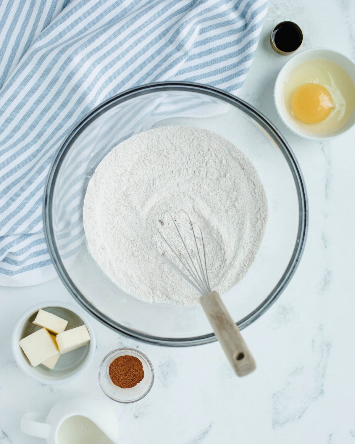 Flour, cornstarch, sugar, baking powder, salt, cinnamon, and nutmeg whisked together in a glass bowl.