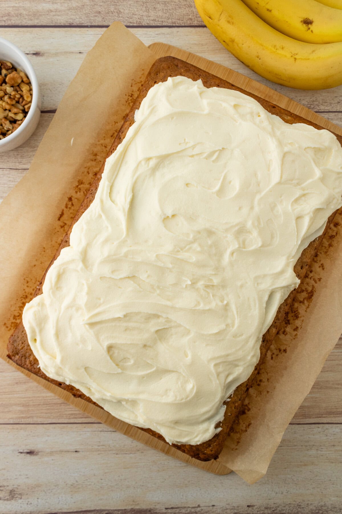 Cream cheese frosting spread evenly over banana bread bars.