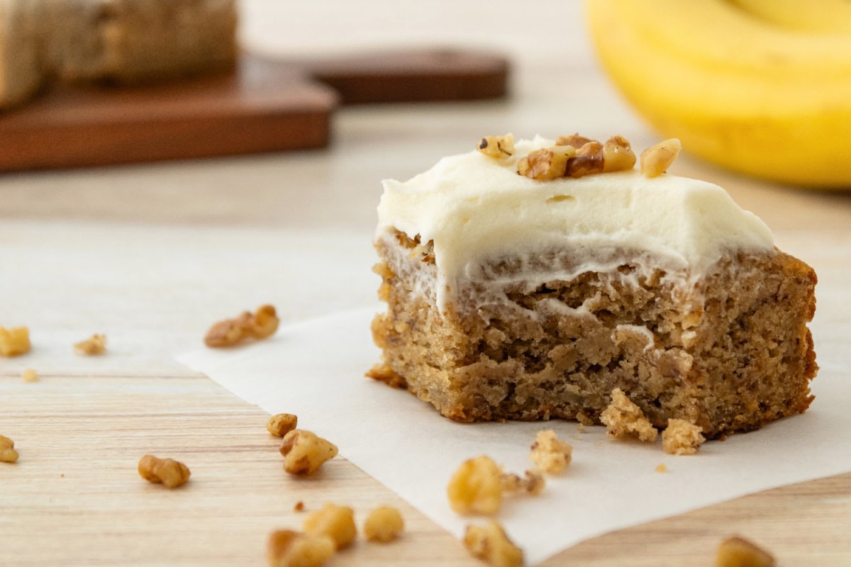 An up close look at the moist texture of a banana bread bar ready to serve.