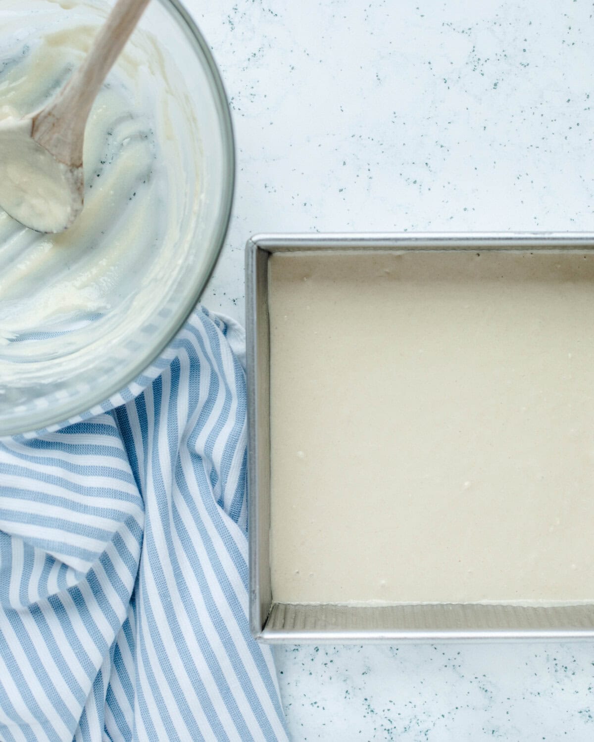 Cake batter poured evenly into a prepared 8x8 baking pan.