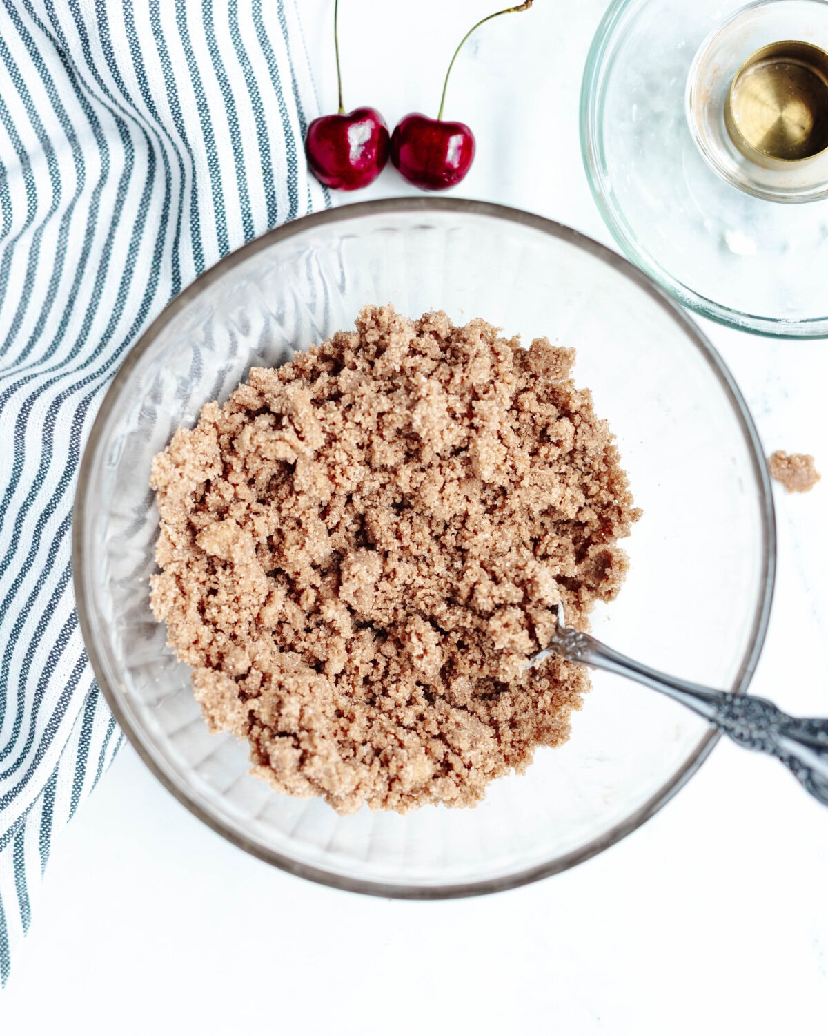 Flour, sugar, cinnamon, salt, and butter combined in a mixing bowl using a fork.