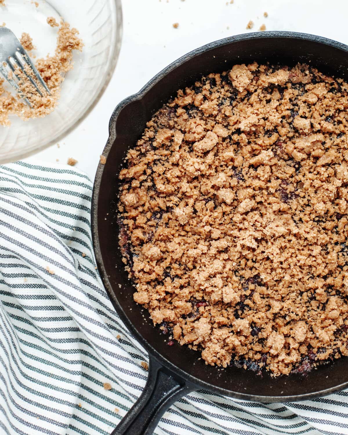 A streusel topping consisting of flour, sugar, cinnamon, butter, and salt on top of a cherry mixture.