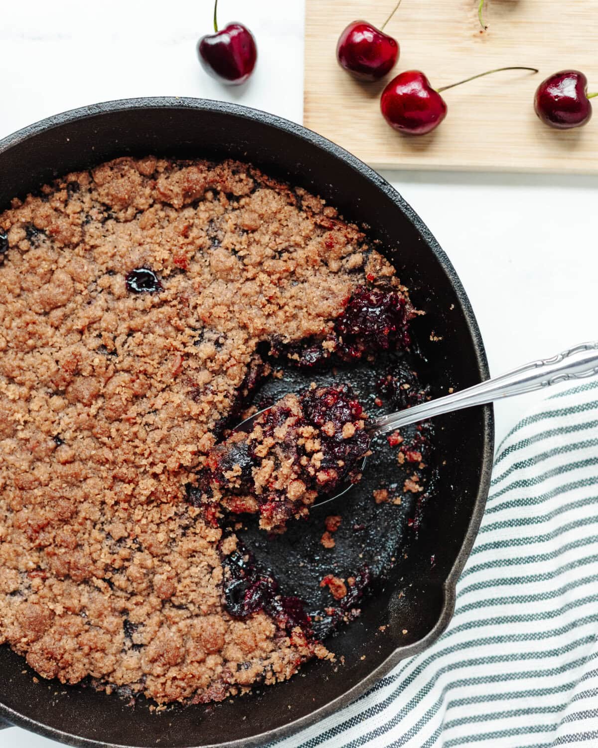 Cherry cobbler made in a cast iron skillet.