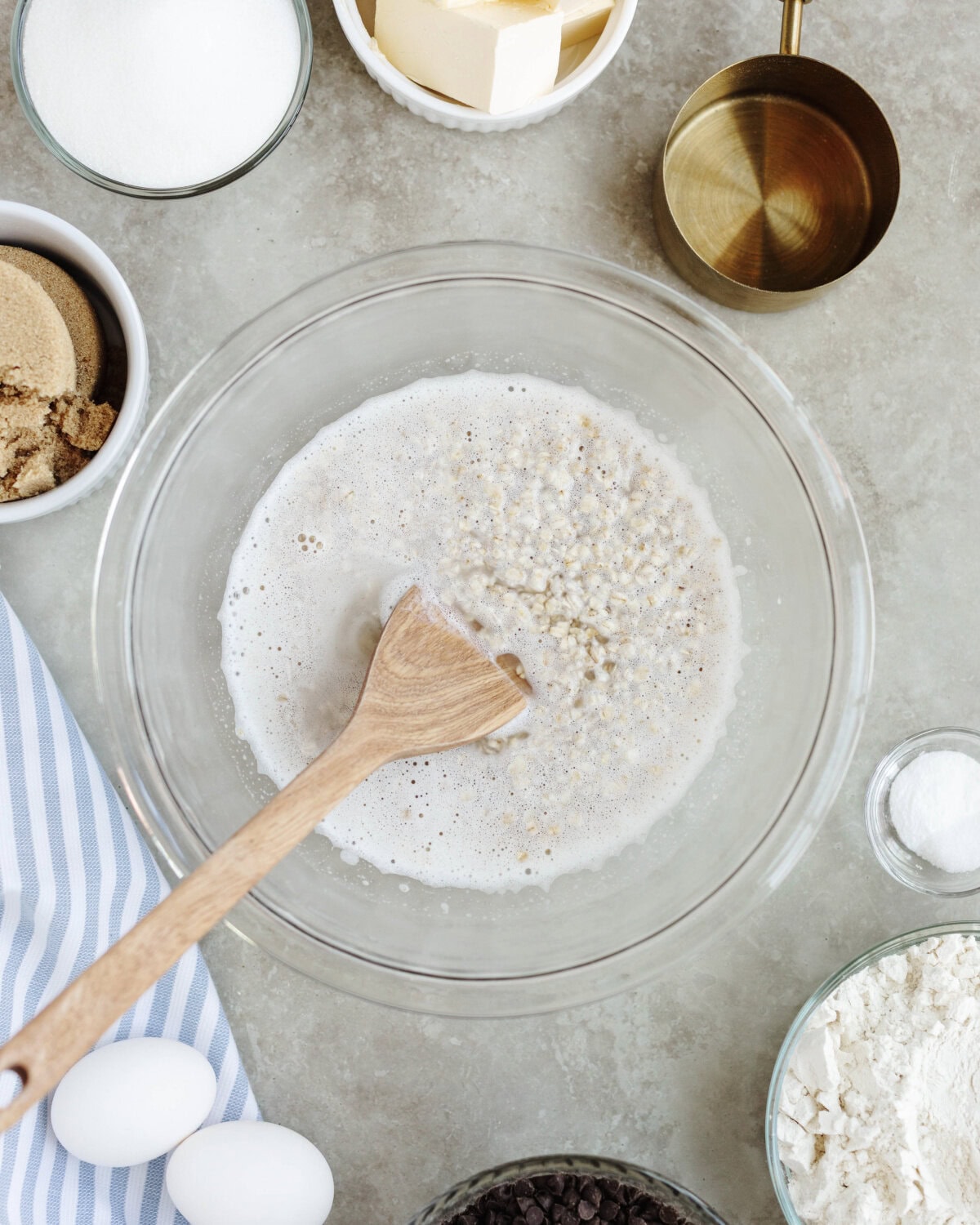 Boiling water poured over oats in a mixing bowl.