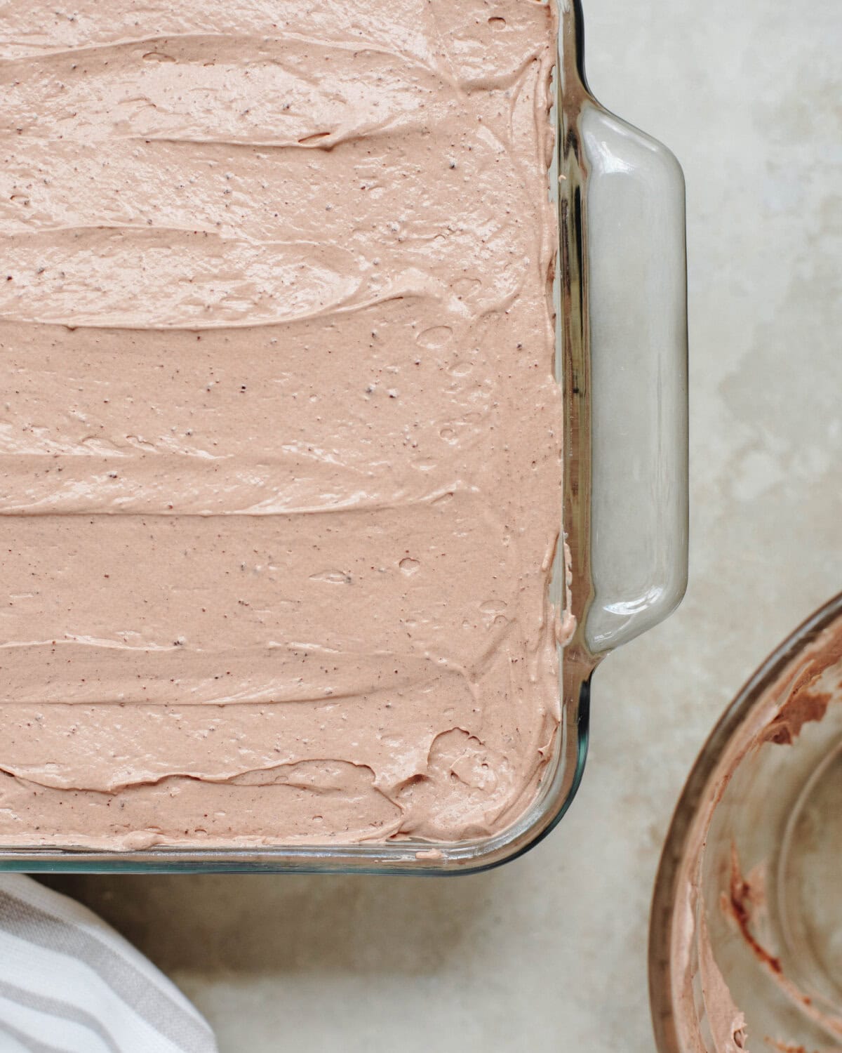 A chocolate pudding mixture spread on top of a cream peanut butter cheesecake layer.