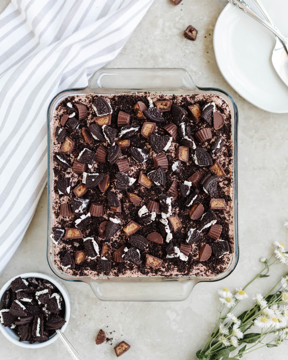 Chocolate peanut butter dirt cake ready to serve from a glass 8x8 pan.
