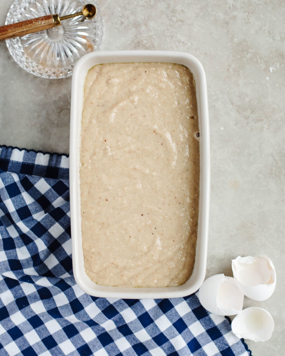 Quick bread batter spread evenly into a prepared loaf pan.