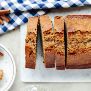 Cinnamon Applesauce Bread sliced on a white tray and ready to serve.