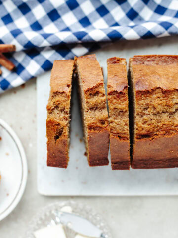 Cinnamon Applesauce Bread sliced on a white tray and ready to serve.