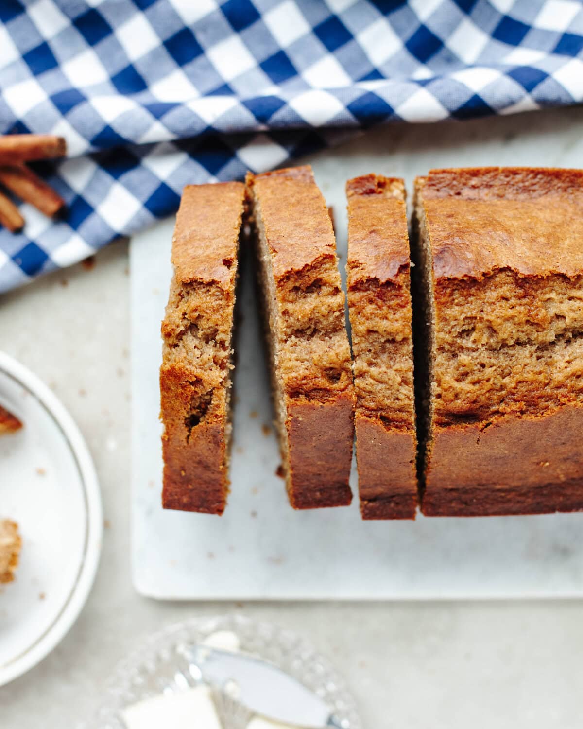 Cinnamon Applesauce Bread sliced on a white tray and ready to serve.