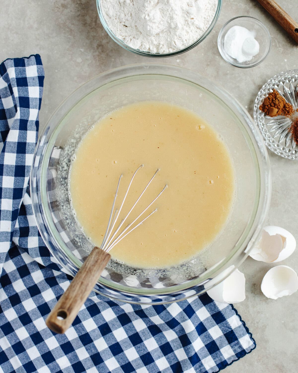 Wet ingredients whisked together in a glass mixing bowl.
