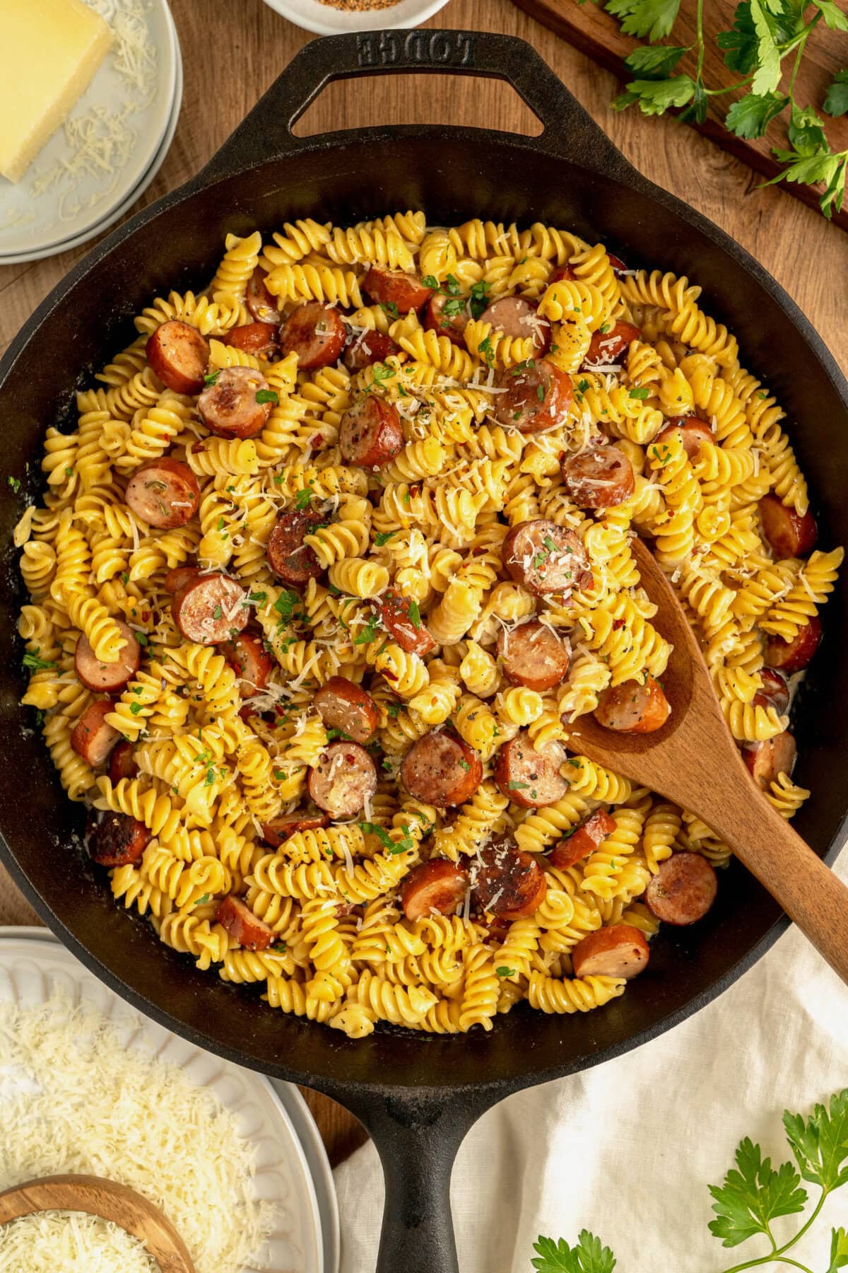 Creamy Cajun sausage pasta in a cast iron skillet.