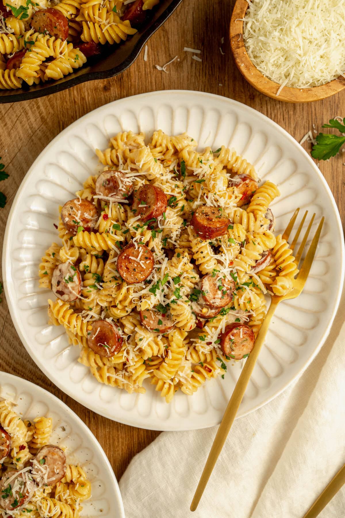 A white plate with a serving of Cajun sausage pasta ready to enjoy.