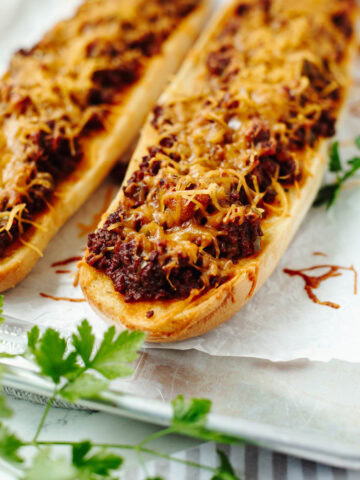 Cooked garlic bread sloppy joes ready to slice and serve from the oven.