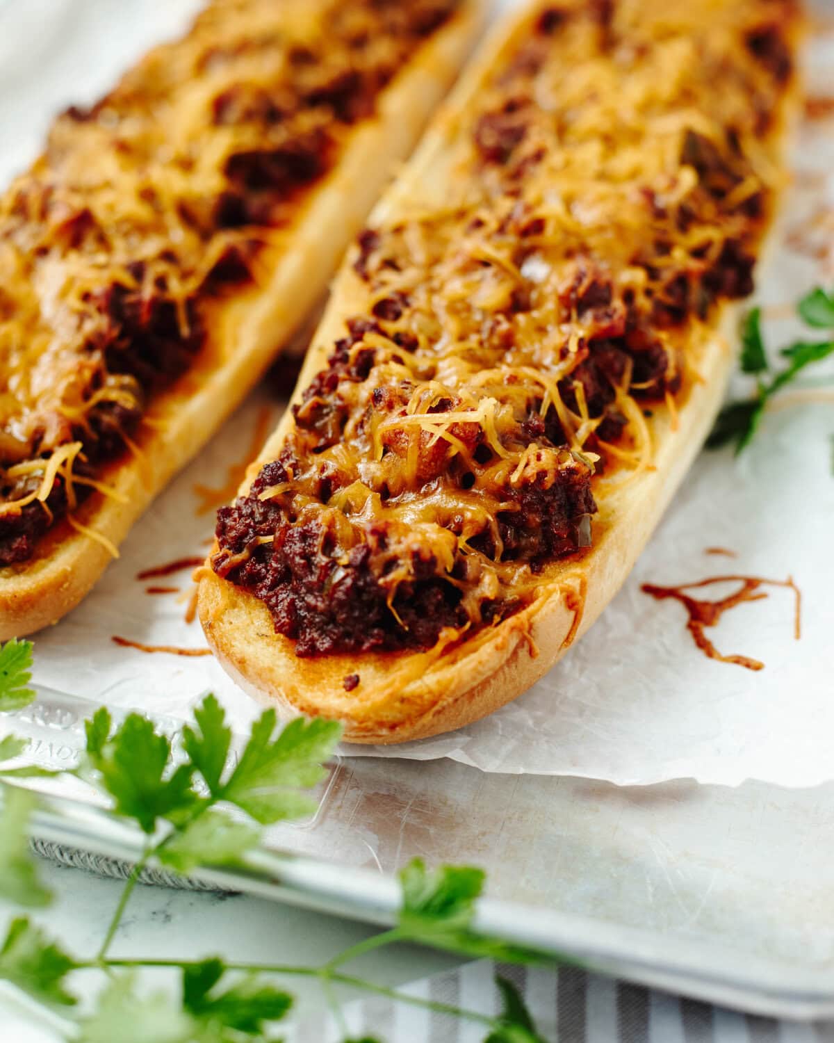 Cooked garlic bread sloppy joes ready to slice and serve from the oven.