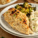 Melt in your mouth chicken on a dinner plate served with mashed potatoes and broccoli.