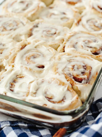 A glass baking pan with homemade cinnamon rolls.