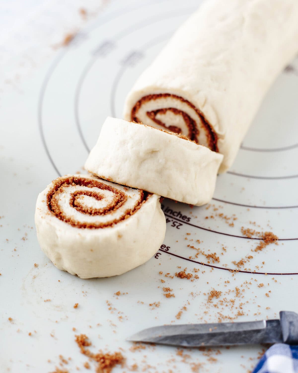 Homemade dough rolled up and sliced to make individual rolls.