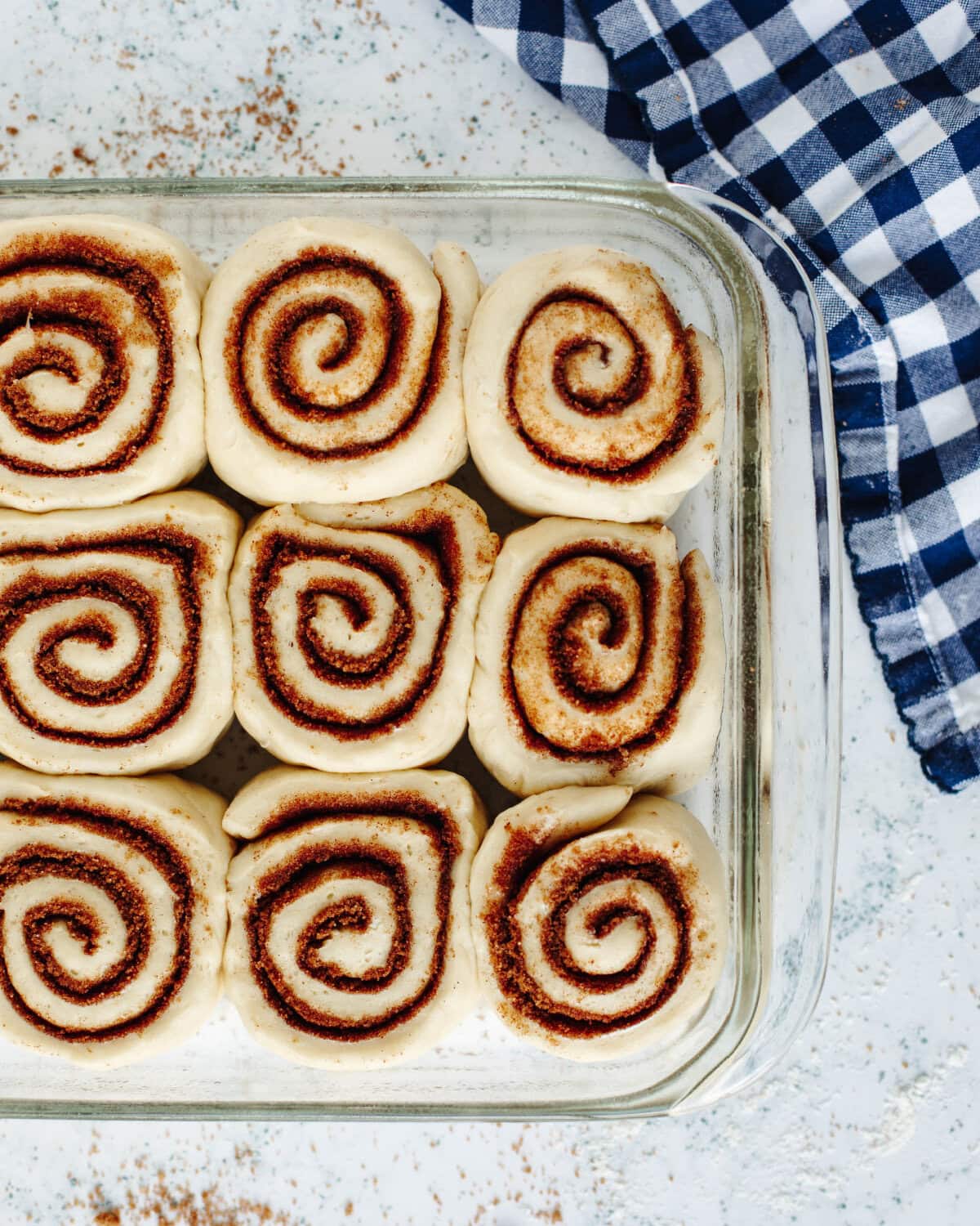 Risen cinnamon rolls ready for the oven.