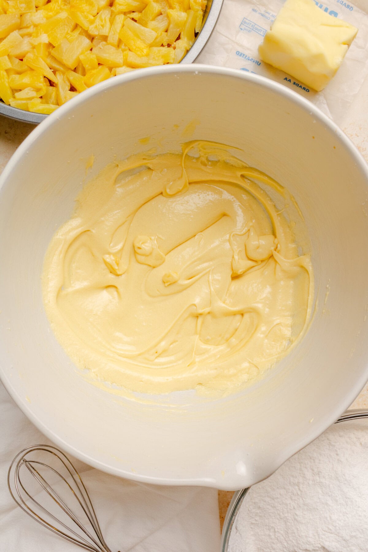 Smooth homemade cake batter prepared with reserved pineapple juice.