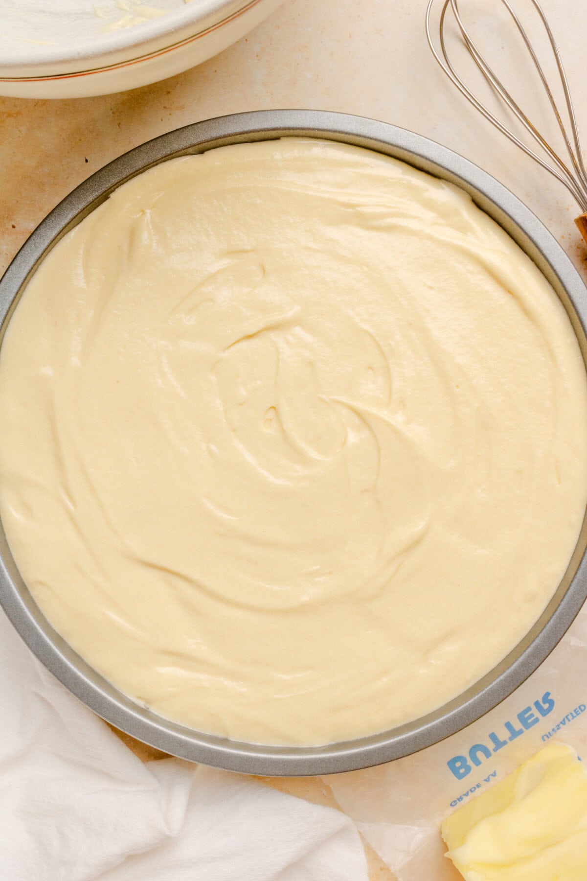 Cake batter spread evenly over the pineapple topping before baking.