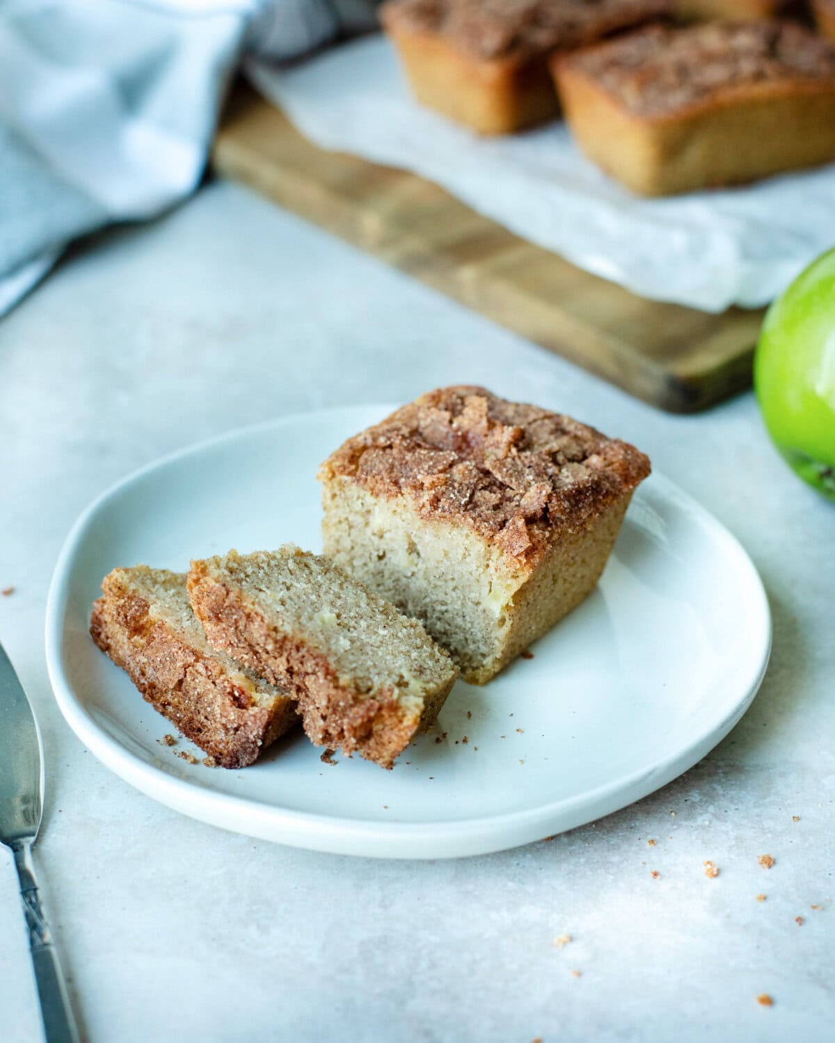 Snickerdoodle apple bread sliced on a white plate.