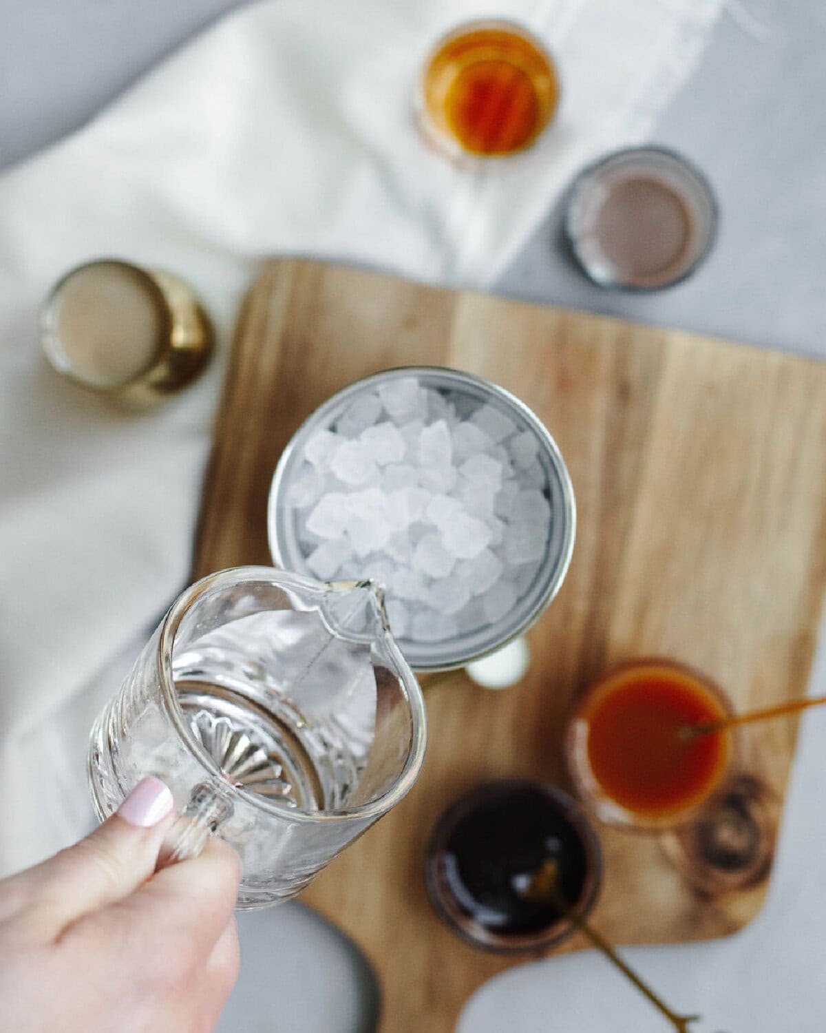Vodka poured into an ice filled cocktail shaker.