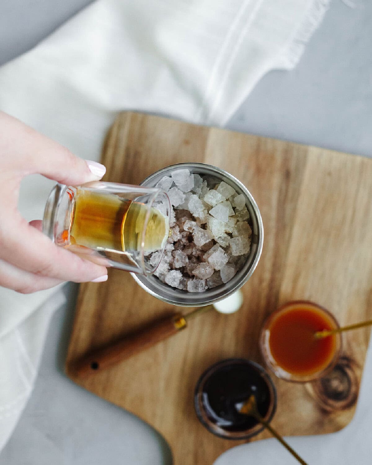 Amaretto added to a cocktail shaker.