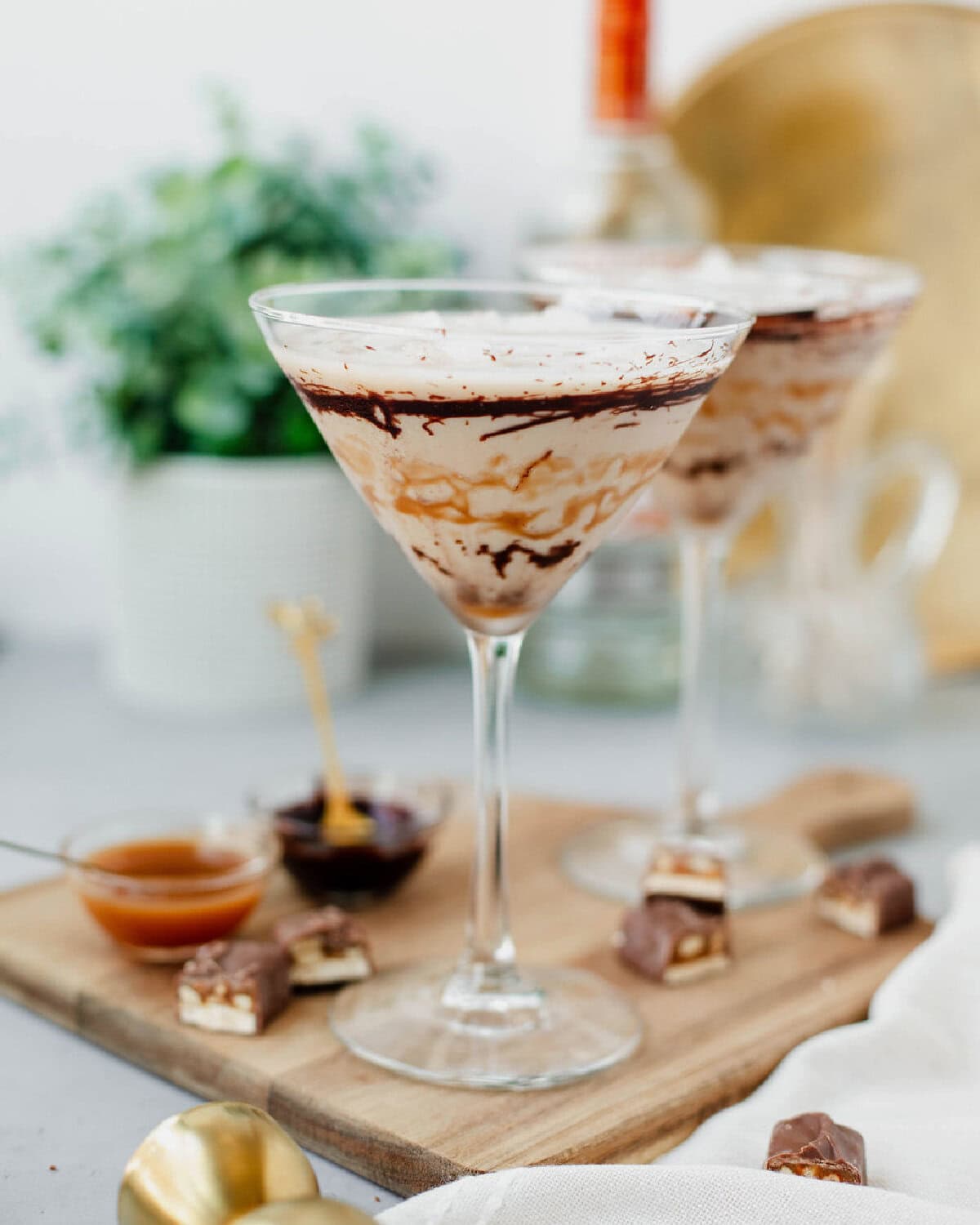 snickers martini in a drizzled garnished martini glass.