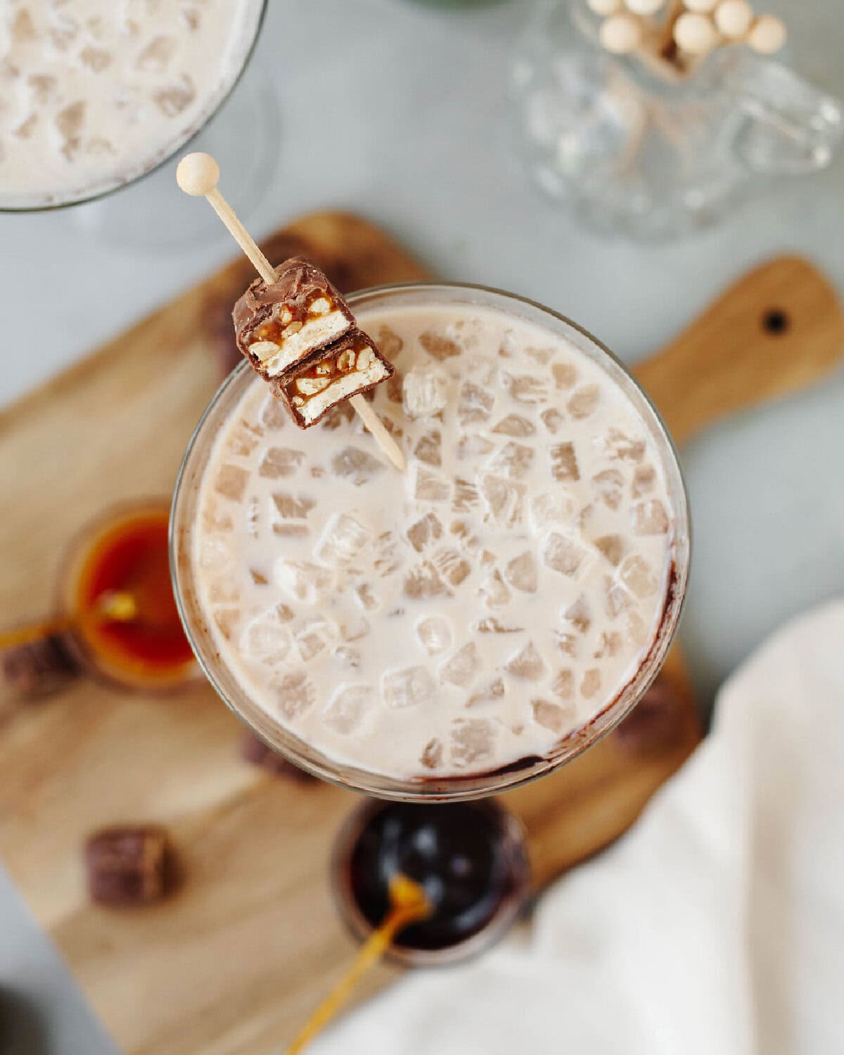 A snickers candy bar garnishing a martini.