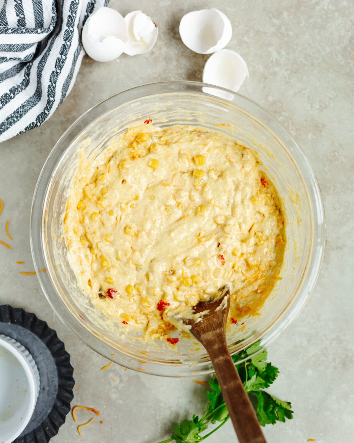 Mexicorn folded into prepared cornbread batter in a mixing bowl.
