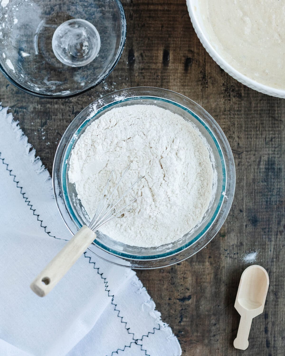 Flour, salt, baking powder, and baking soda combined in a glass mixing bowl.