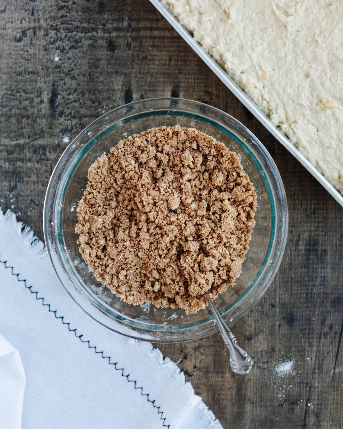 Flour, brown sugar, butter, and cinnamon combined in a mixing bowl to create a crumb topping.
