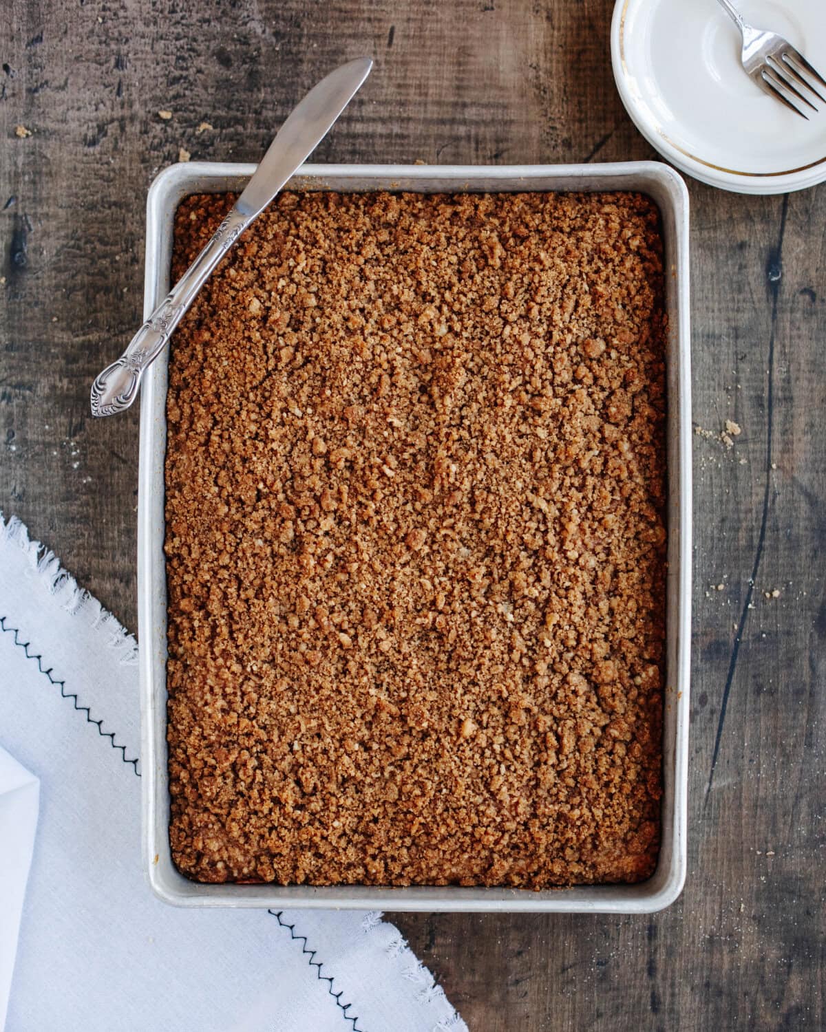 A streusel topped banana coffee cake in a 9x13 baking pan.