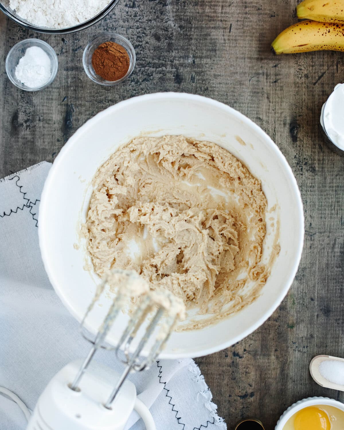 Butter, brown sugar, and white granulated sugar creamed together using an electric hand mixer.