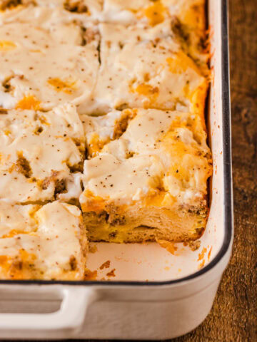 Biscuits and Gravy Breakfast Casserole baked in a white 9x13 baking pan and ready to serve.