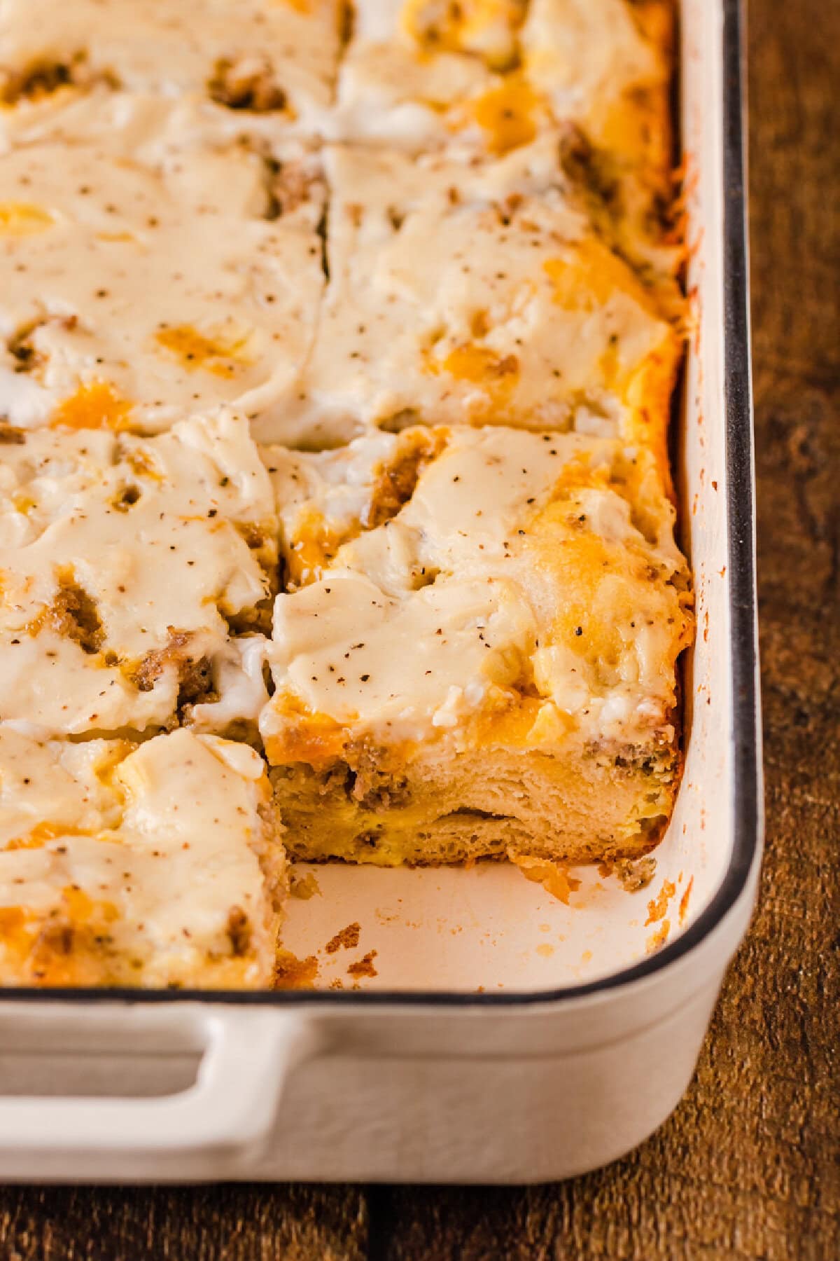 Biscuits and Gravy Breakfast Casserole baked in a white 9x13 baking pan and ready to serve.