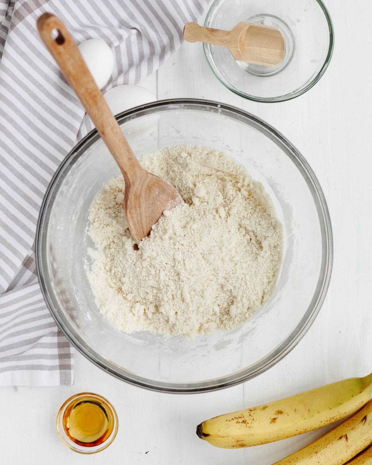 Flour, salt, baking powder, baking soda combined in a glass mixing bowl.