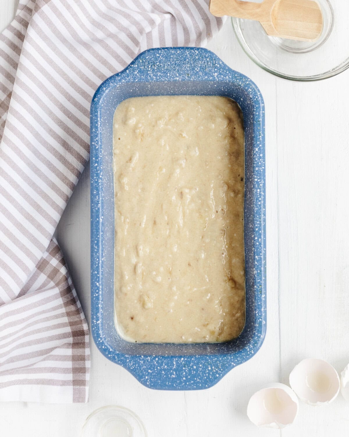 Batter spread evenly into a blue prepared loaf pan.