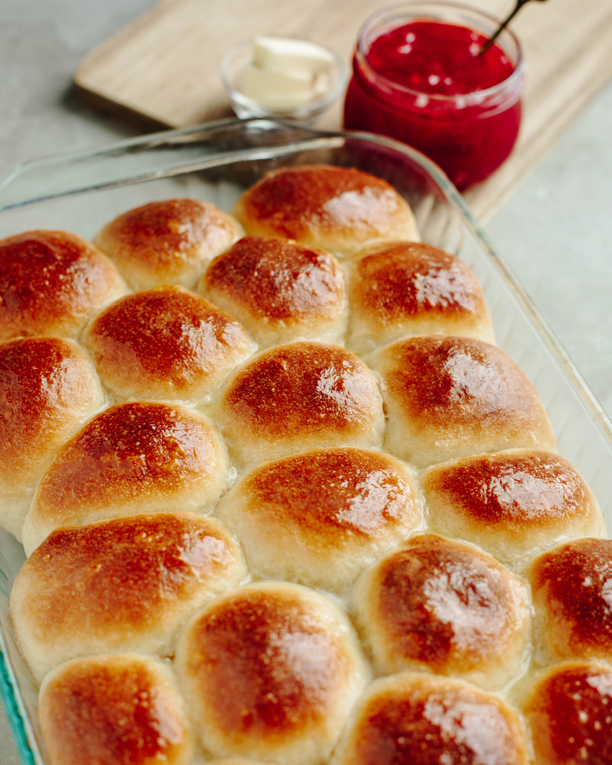 Buttery dinner rolls baked in a glass 9x13 baking pan.