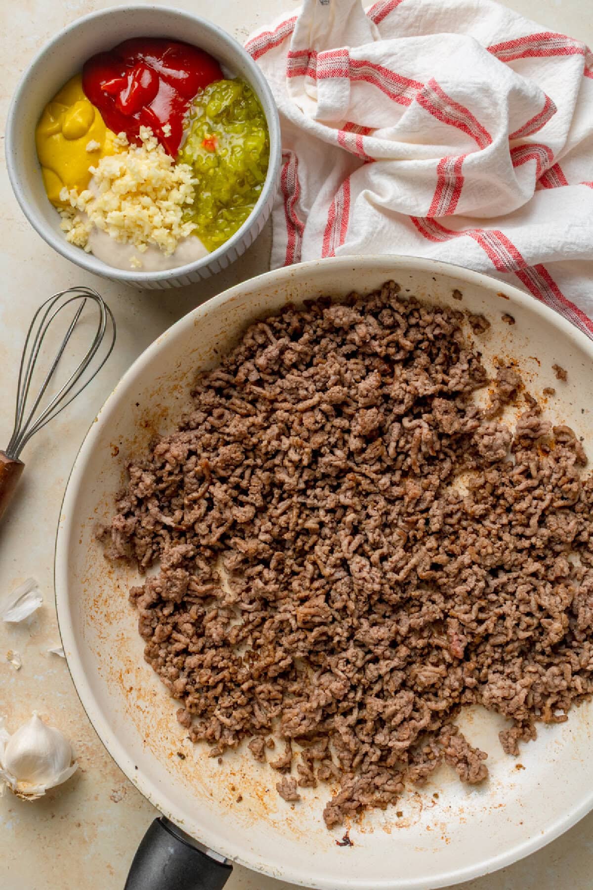Ground beef cooking in a skillet until no longer pink.
