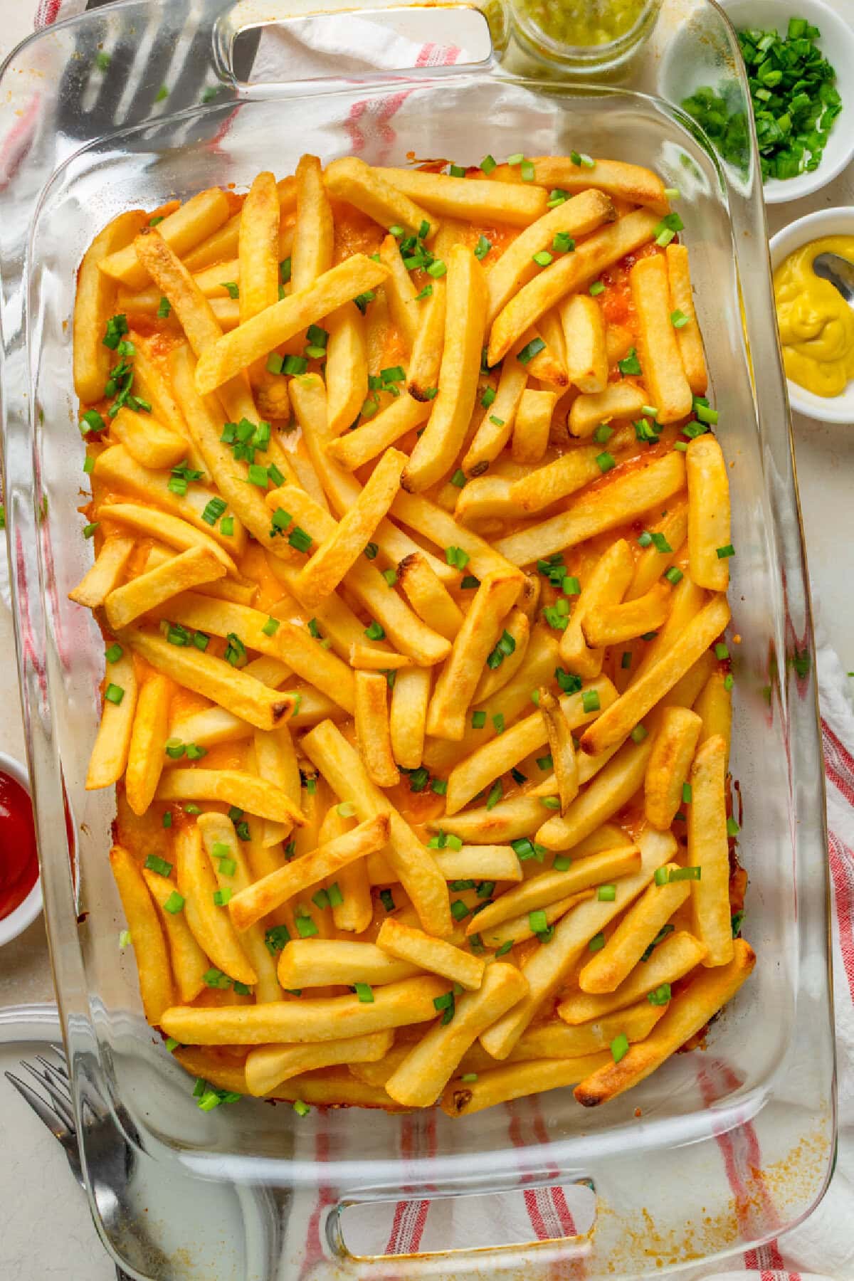 A top look at baked cheeseburger French fry casserole in a glass 9x13 baking dish.