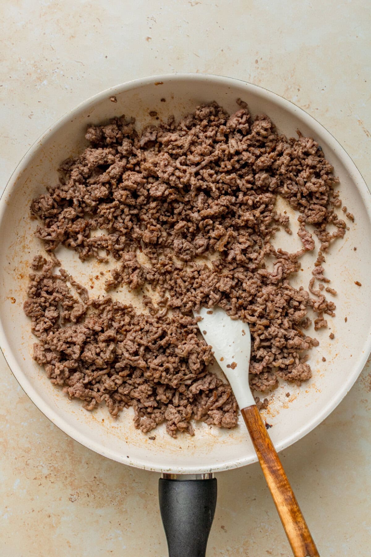Cooked ground beef in a skillet.