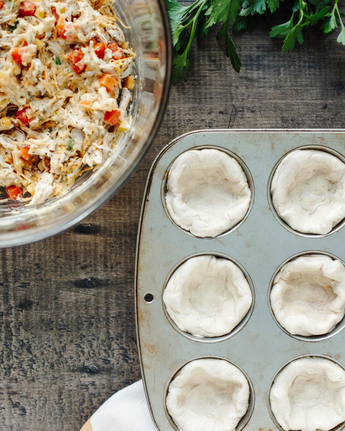 Biscuits pushed individually into muffin cups to form a crust.