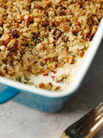 Baked stuffing topped chicken pot pie in a blue ceramic baking dish.