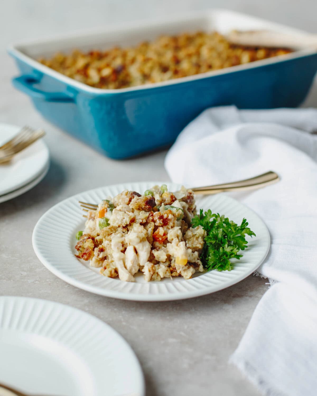 A serving of chicken pot pie with stuffing on a white dinner plate.
