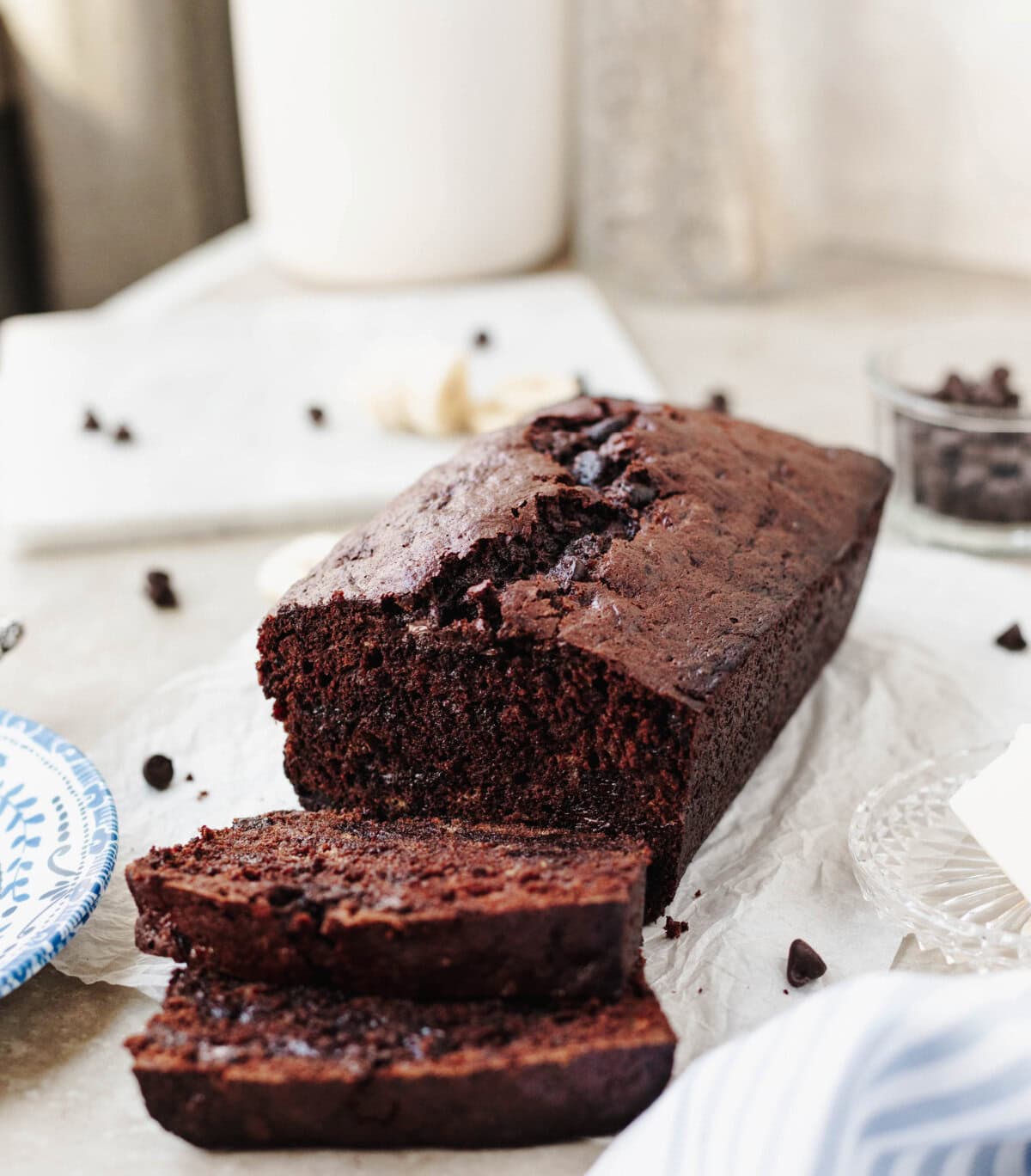 A sliced loaf of double chocolate banana bread on a serving platter.