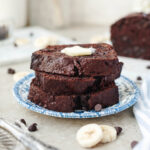 Stacked slices of quick bread with chocolate and banana throughout.