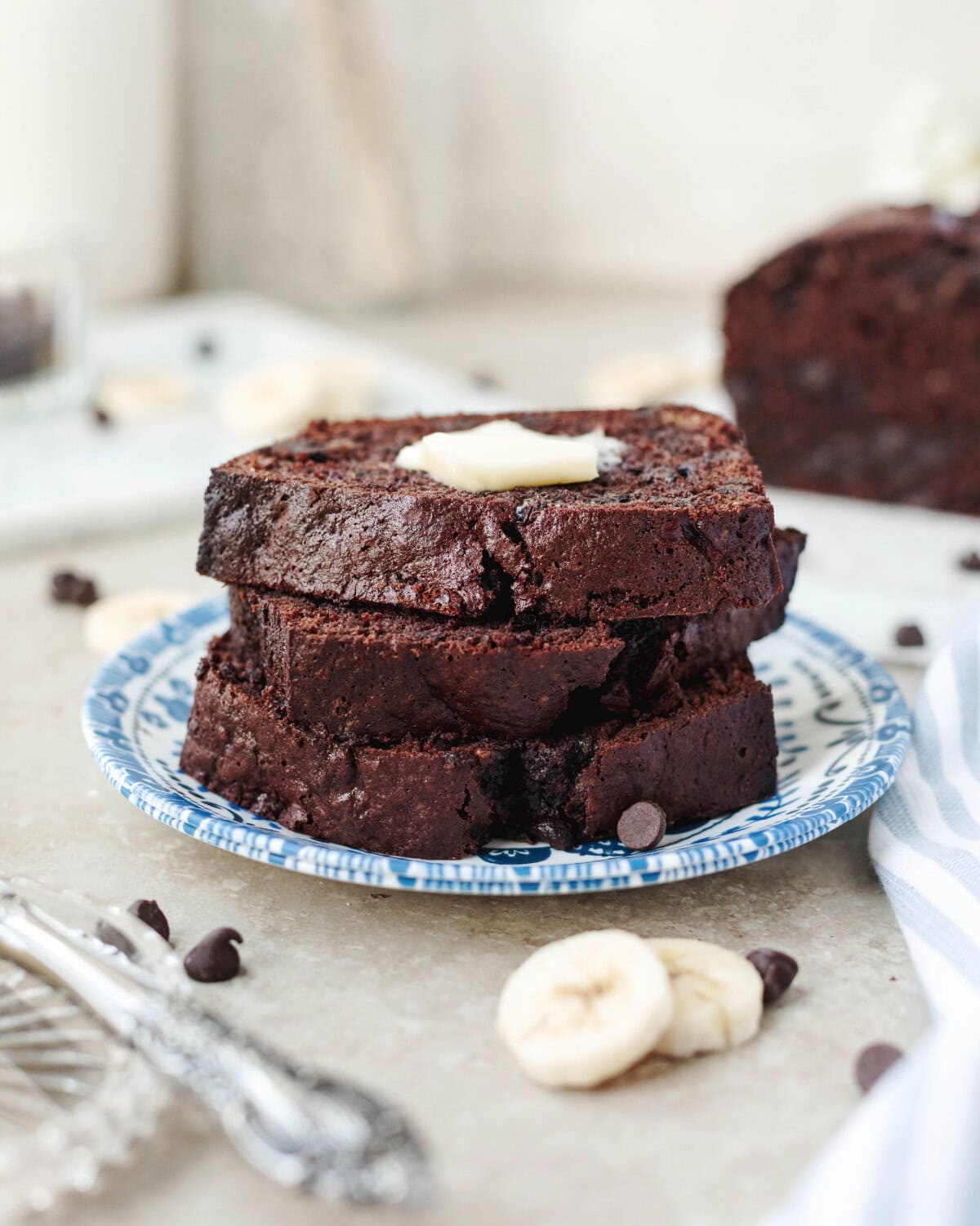 Stacked slices of quick bread with chocolate and banana throughout.