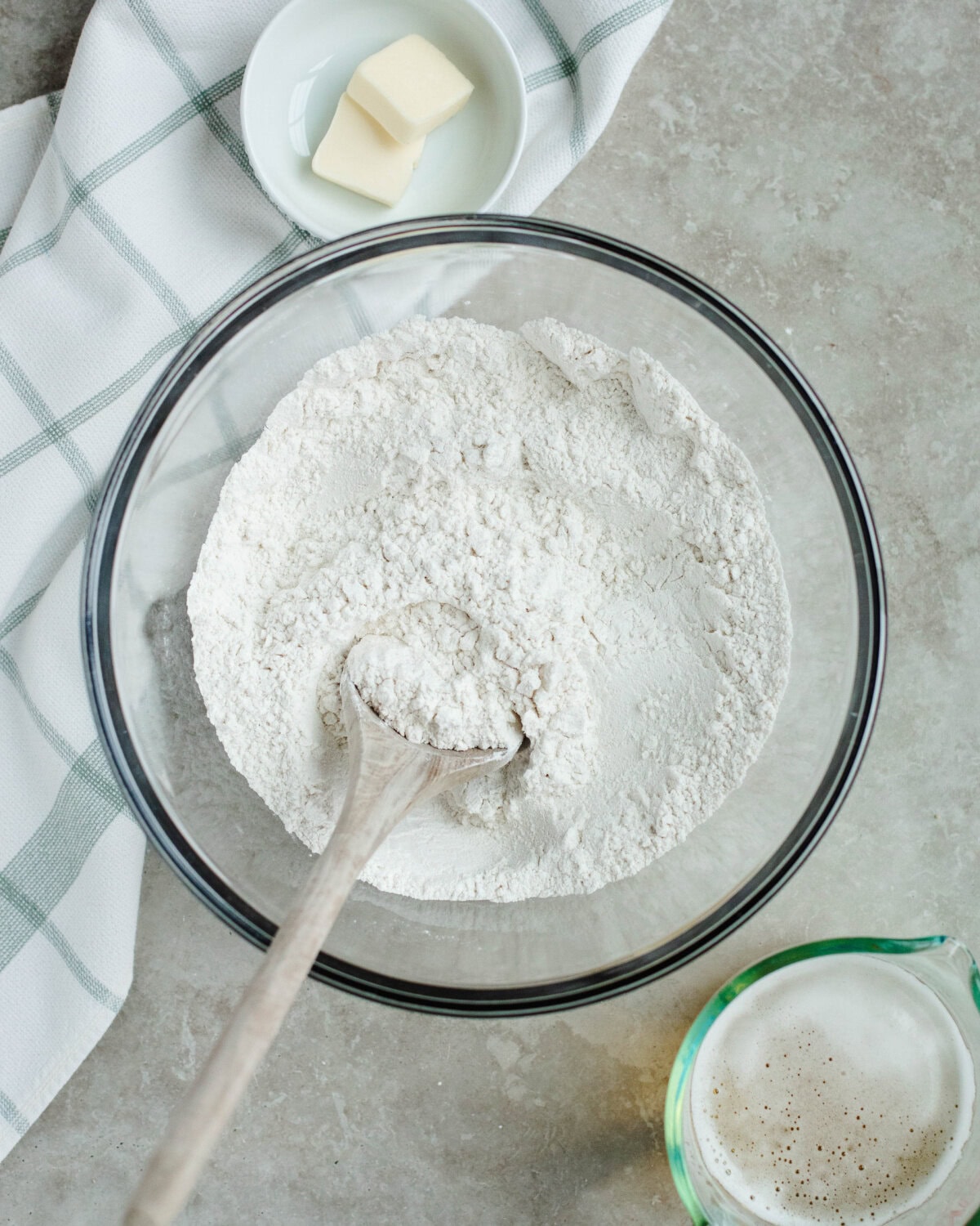 Flour, baking powder, salt, and sugar combined in a glass mixing bowl.